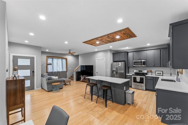 358 London Rd, Asheville, NC 28803 - kitchen featuring appliances with stainless steel finishes, a sink, open floor plan, a center island, and light countertops