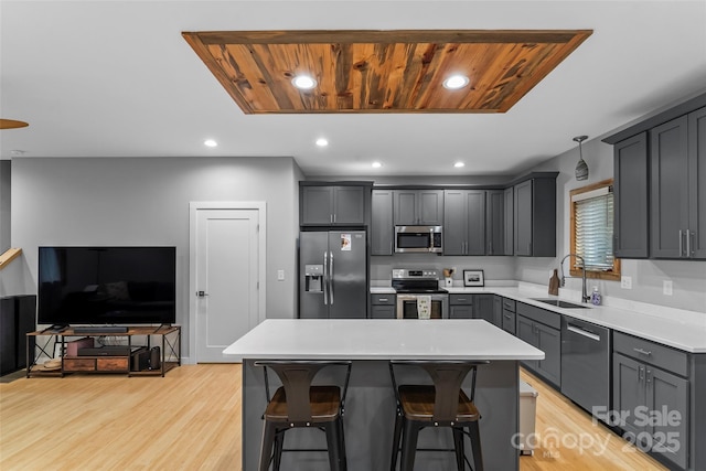 358 London Rd, Asheville, NC 28803 - kitchen featuring stainless steel appliances, a sink, light wood-style floors, a breakfast bar, and recessed lighting