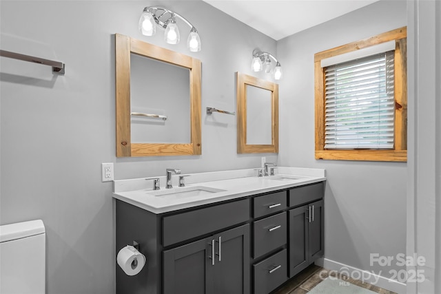 358 London Rd, Asheville, NC 28803 - bathroom featuring double vanity, toilet, and baseboards