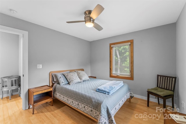 358 London Rd, Asheville, NC 28803 - bedroom with light wood-style flooring, a ceiling fan, and baseboards