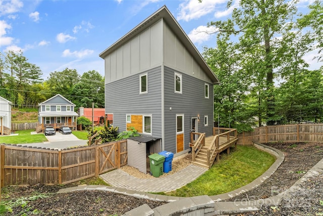 358 London Rd, Asheville, NC 28803 - back of property with board and batten siding, a wooden deck, and a fenced backyard