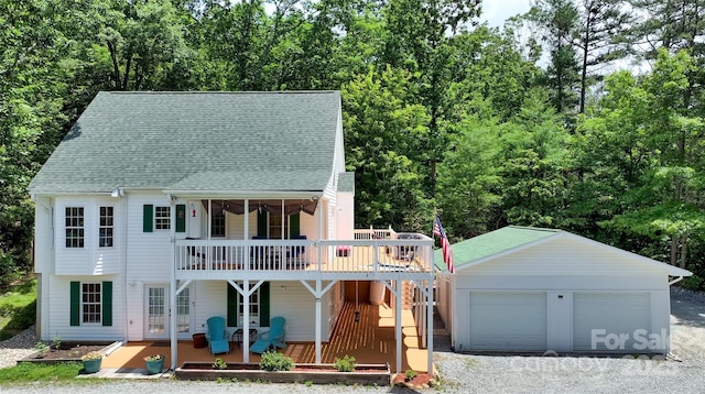 186 Hawks Point Dr, Zirconia, NC 28790 - view of front of house featuring a deck, an outdoor structure, roof with shingles, and a detached garage