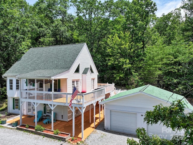 186 Hawks Point Dr, Zirconia, NC 28790 - view of front facade with roof with shingles, a deck, french doors, driveway, and a detached garage