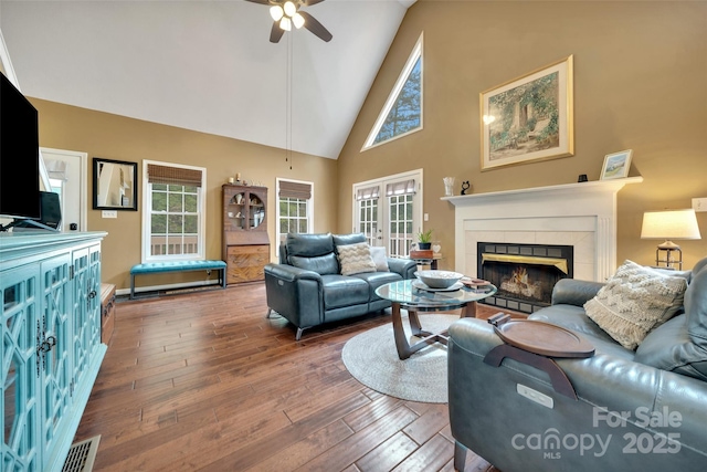 186 Hawks Point Dr, Zirconia, NC 28790 - living area with ceiling fan, a warm lit fireplace, high vaulted ceiling, and hardwood / wood-style floors