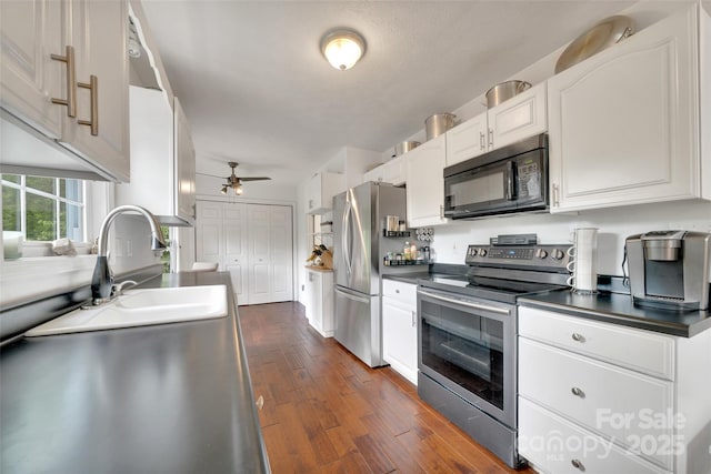 186 Hawks Point Dr, Zirconia, NC 28790 - kitchen with stainless steel appliances, dark countertops, ceiling fan, and white cabinets
