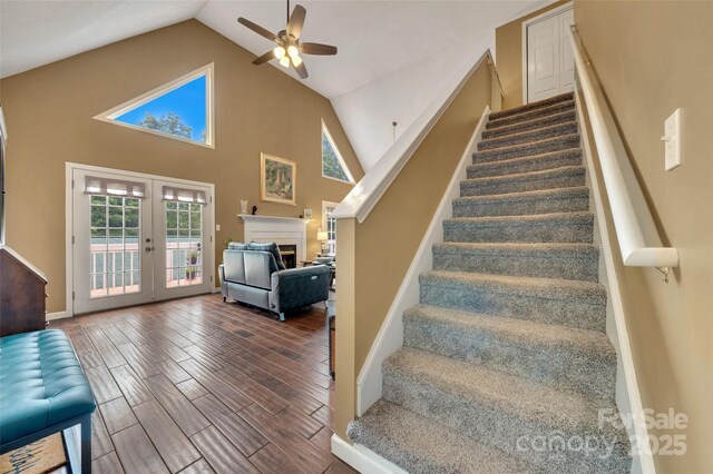 186 Hawks Point Dr, Zirconia, NC 28790 - stairs featuring ceiling fan, french doors, wood finished floors, plenty of natural light, and high vaulted ceiling