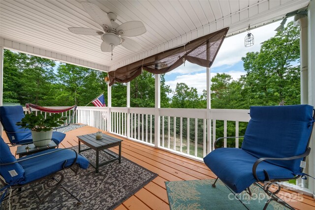 186 Hawks Point Dr, Zirconia, NC 28790 - deck featuring a ceiling fan and view of wooded area