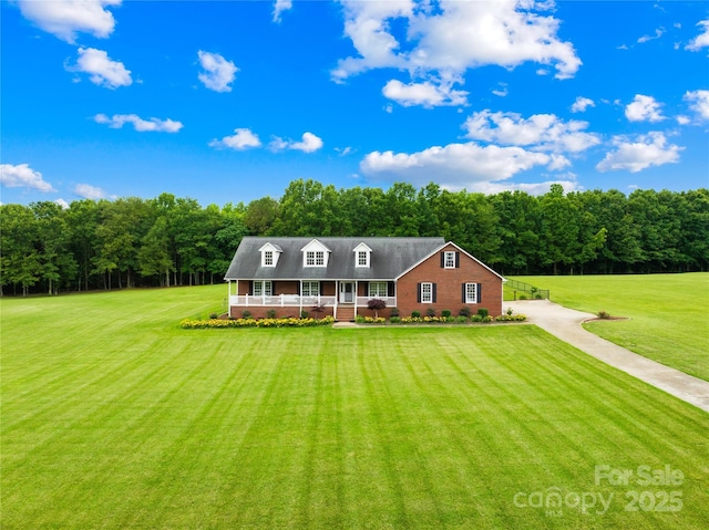 106 Laren Rd, Shelby, NC 28152 - cape cod-style house with a front lawn, covered porch, and a view of trees