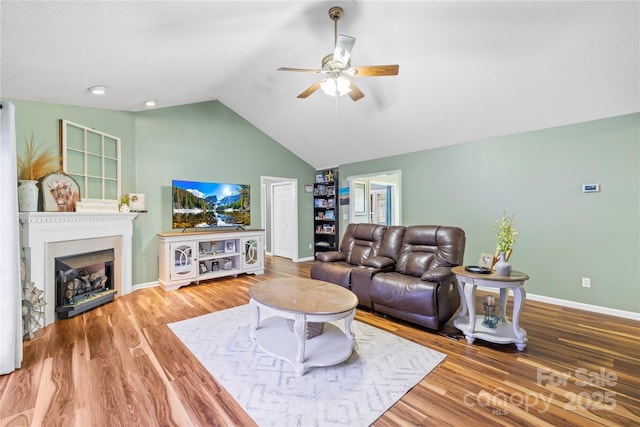 106 Laren Rd, Shelby, NC 28152 - living area featuring ceiling fan, vaulted ceiling, a fireplace, and wood finished floors