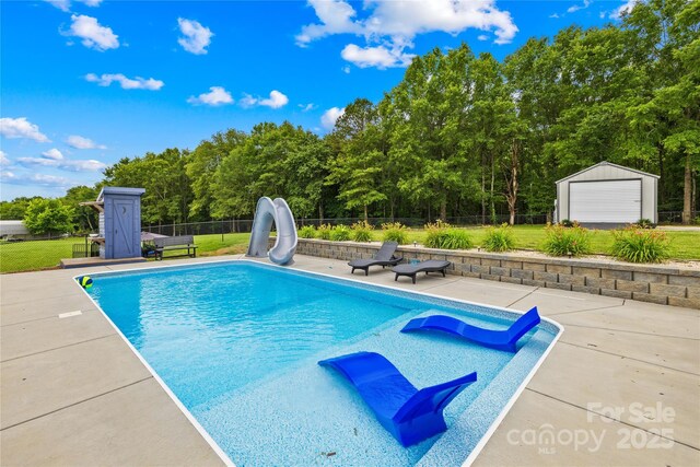 106 Laren Rd, Shelby, NC 28152 - view of pool with a water slide, a fenced backyard, a patio area, and a storage shed