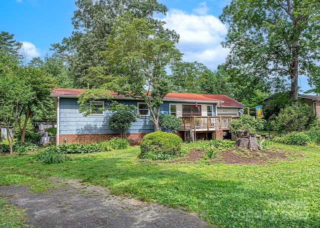603 S Orchard Rd, Flat Rock, NC 28731 - rear view of property with a wooden deck and a lawn