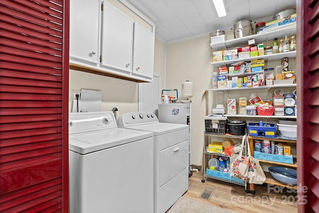 603 S Orchard Rd, Flat Rock, NC 28731 - laundry area with cabinet space, separate washer and dryer, light wood-style flooring, crown molding, and water heater