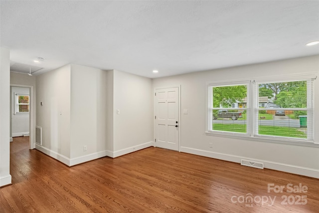 4906 Charleston Dr, Charlotte, NC 28212 - empty room featuring wood finished floors, healthy amount of natural light, attic access, and recessed lighting
