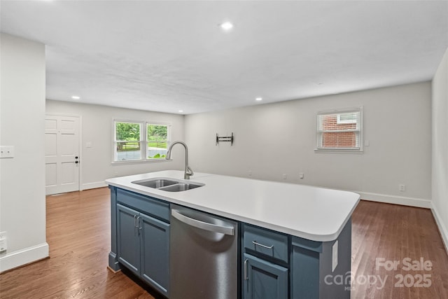 4906 Charleston Dr, Charlotte, NC 28212 - kitchen featuring stainless steel dishwasher, dark wood-style flooring, light countertops, a center island with sink, and recessed lighting