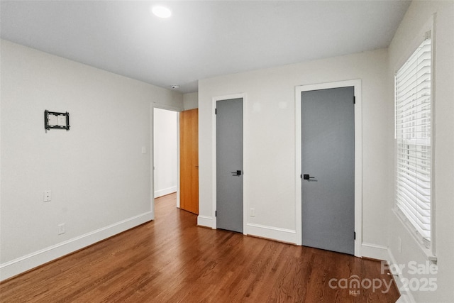 4906 Charleston Dr, Charlotte, NC 28212 - unfurnished bedroom with wood finished floors and two closets