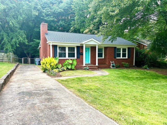 4906 Charleston Dr, Charlotte, NC 28212 - view of front of house with a chimney, concrete driveway, brick siding, and roof with shingles