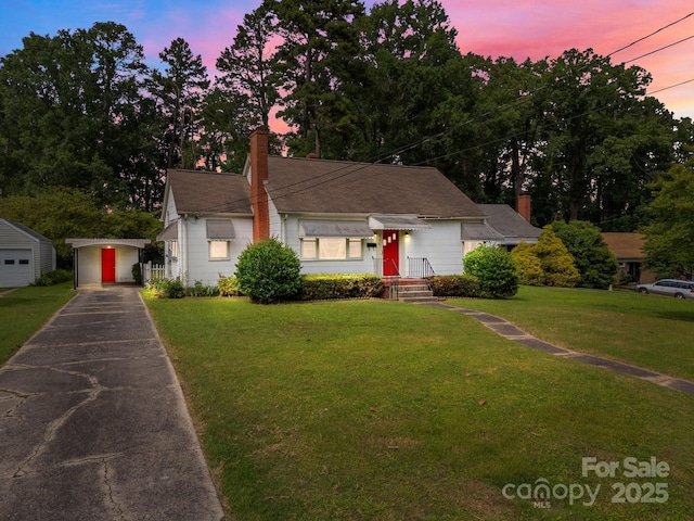 216 Hillcrest Pl, Salisbury, NC 28144 - view of front of property featuring a chimney, driveway, a yard, and an outdoor structure