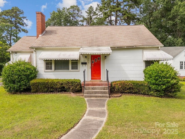 216 Hillcrest Pl, Salisbury, NC 28144 - cape cod home with a chimney, a front lawn, and roof with shingles