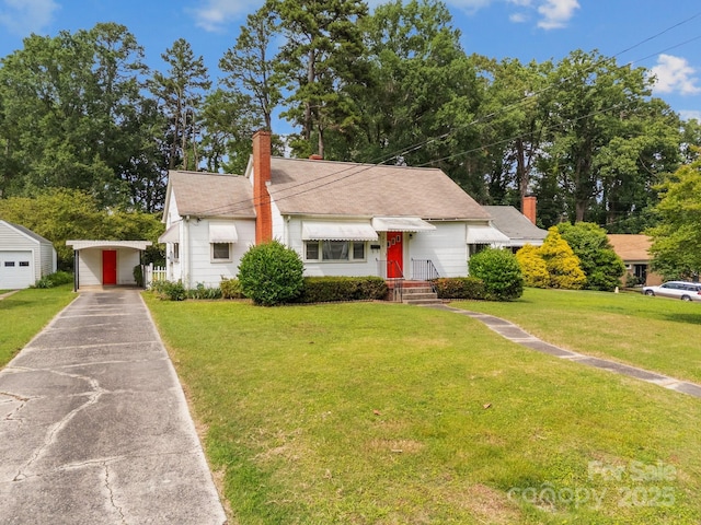216 Hillcrest Pl, Salisbury, NC 28144 - bungalow-style house featuring a chimney, an outdoor structure, a front lawn, a carport, and driveway