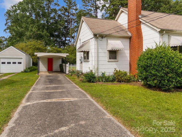 216 Hillcrest Pl, Salisbury, NC 28144 - view of side of home featuring roof with shingles, a lawn, an outdoor structure, a chimney, and a garage