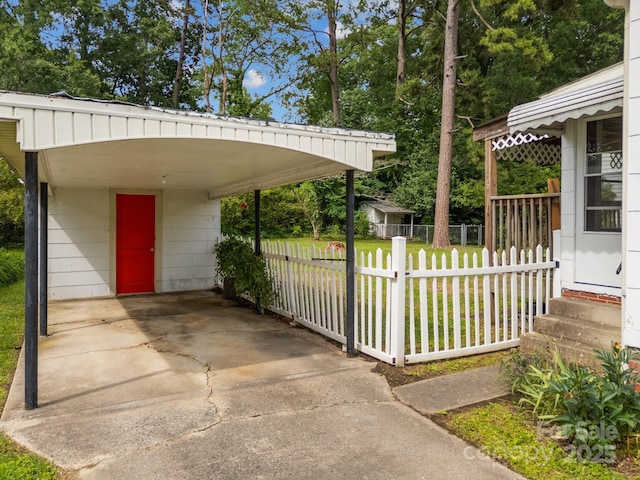 216 Hillcrest Pl, Salisbury, NC 28144 - view of parking / parking lot featuring a carport, concrete driveway, and entry steps