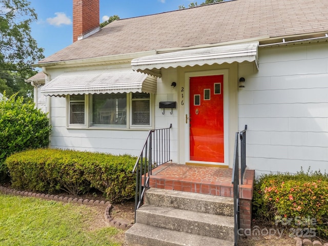 216 Hillcrest Pl, Salisbury, NC 28144 - doorway to property featuring a chimney and roof with shingles