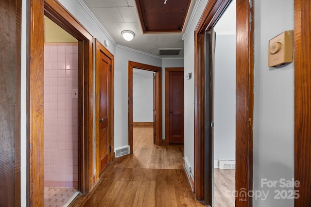 216 Hillcrest Pl, Salisbury, NC 28144 - corridor with wood finished floors, attic access, ornamental molding, and baseboards