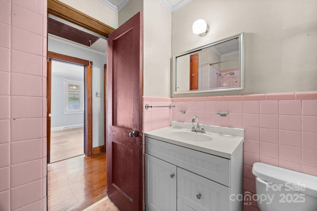 216 Hillcrest Pl, Salisbury, NC 28144 - bathroom with crown molding, tile walls, wood finished floors, vanity, and toilet
