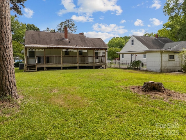 216 Hillcrest Pl, Salisbury, NC 28144 - back of property featuring a chimney, a wooden deck, and a fire pit