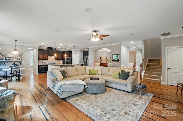 110 St Sophia Ct, Mooresville, NC 28117 - living room featuring arched walkways, ceiling fan, light wood-type flooring, crown molding, and recessed lighting
