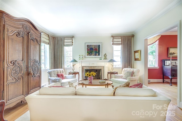 1021 Isleworth Ave, Charlotte, NC 28203 - living room featuring light wood-style flooring, ornamental molding, a fireplace, and baseboards