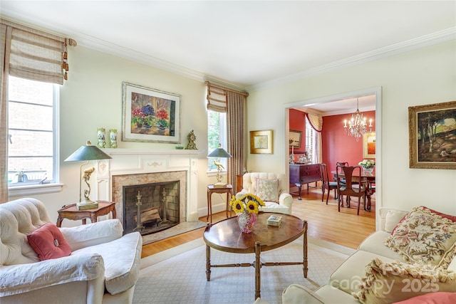 1021 Isleworth Ave, Charlotte, NC 28203 - living area with crown molding, a chandelier, wood finished floors, and a fireplace