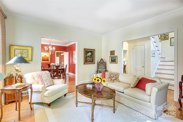 1021 Isleworth Ave, Charlotte, NC 28203 - living area with ornamental molding, stairs, light wood-style floors, a chandelier, and baseboards