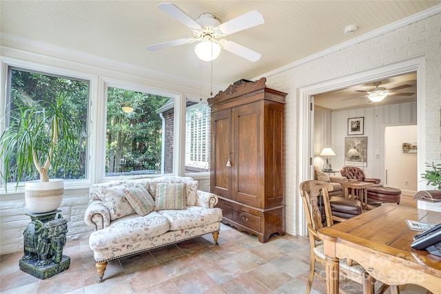 1021 Isleworth Ave, Charlotte, NC 28203 - living area featuring crown molding, a ceiling fan, plenty of natural light, and light stone finish floors