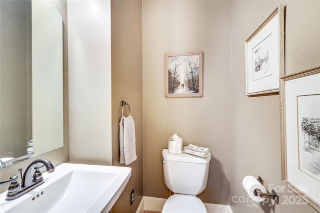 1021 Isleworth Ave, Charlotte, NC 28203 - bathroom with a sink, toilet, and baseboards