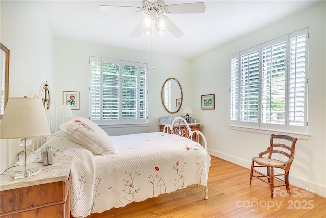 1021 Isleworth Ave, Charlotte, NC 28203 - bedroom featuring multiple windows, light wood-style flooring, baseboards, and ceiling fan