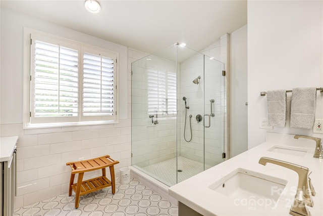 1021 Isleworth Ave, Charlotte, NC 28203 - bathroom with double vanity, a stall shower, and tile walls