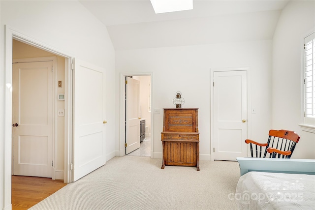 1021 Isleworth Ave, Charlotte, NC 28203 - bedroom with lofted ceiling, a skylight, baseboards, and ensuite bath