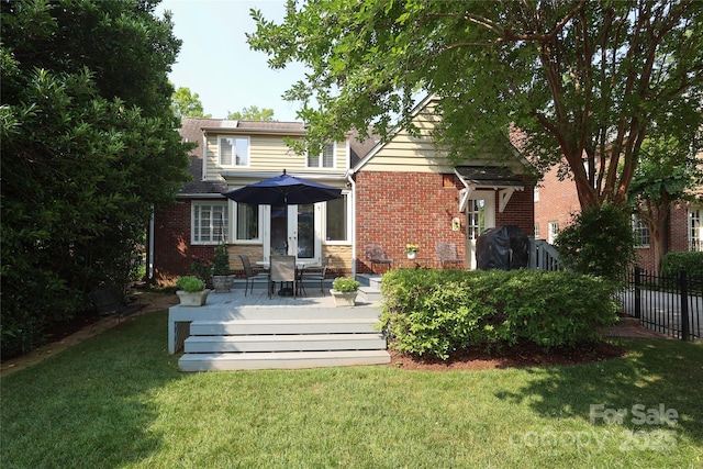 1021 Isleworth Ave, Charlotte, NC 28203 - back of house with brick siding and a wooden deck