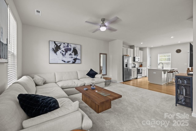 3108 Beeler Ln, Charlotte, NC 28208 - living room with light carpet, ceiling fan, recessed lighting, and baseboards