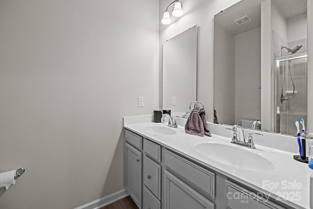 3108 Beeler Ln, Charlotte, NC 28208 - bathroom featuring double vanity, toilet, and a tile shower