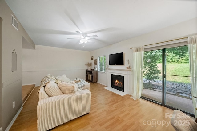 3737 Winding Creek Ln, Charlotte, NC 28226 - living area with light wood-style floors, a fireplace with flush hearth, and a ceiling fan