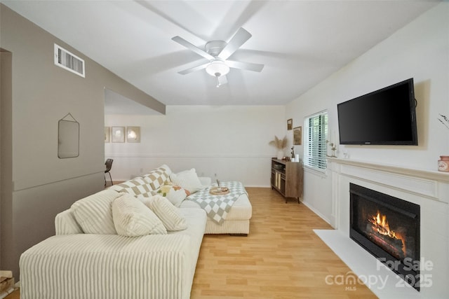 3737 Winding Creek Ln, Charlotte, NC 28226 - living room featuring light wood-type flooring, a fireplace with flush hearth, and a ceiling fan