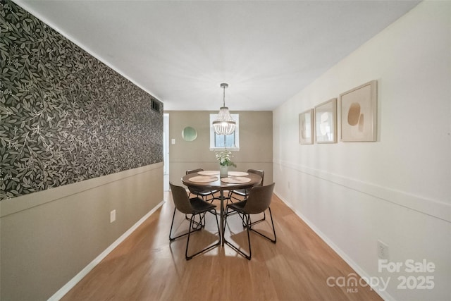 3737 Winding Creek Ln, Charlotte, NC 28226 - dining room with light wood-style flooring, a chandelier, baseboards, and wallpapered walls
