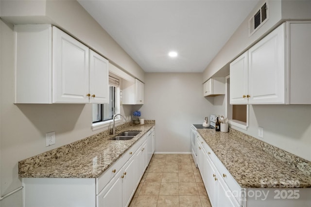 3737 Winding Creek Ln, Charlotte, NC 28226 - kitchen with a sink, white cabinetry, light stone counters, and baseboards