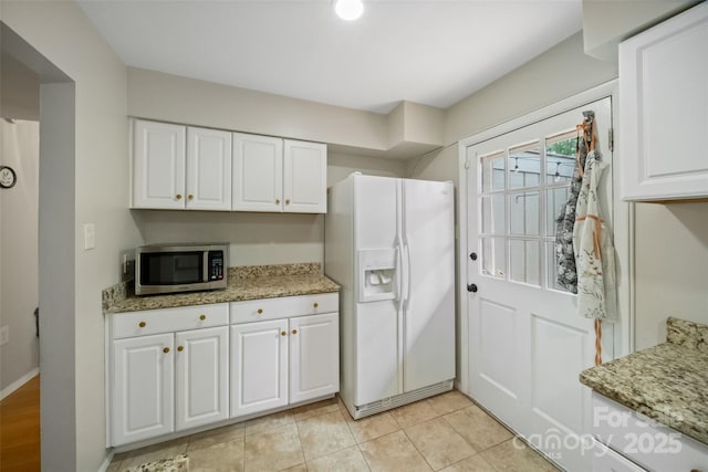 3737 Winding Creek Ln, Charlotte, NC 28226 - kitchen with white fridge with ice dispenser, stainless steel microwave, white cabinetry, and light stone countertops