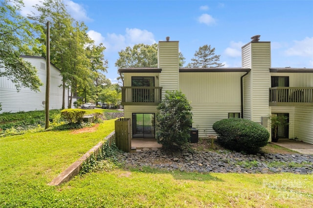 3737 Winding Creek Ln, Charlotte, NC 28226 - rear view of house featuring a lawn, a chimney, and cooling unit