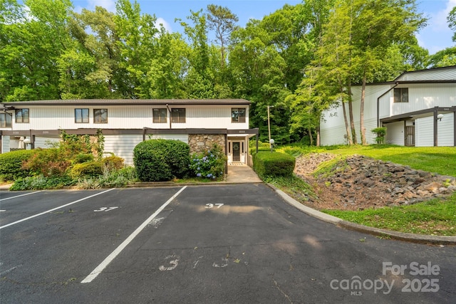 3737 Winding Creek Ln, Charlotte, NC 28226 - view of front of house featuring uncovered parking and stone siding