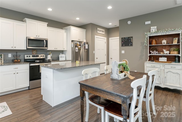 27 Sage Crest Loop, Weaverville, NC 28787 - kitchen featuring stainless steel appliances, dark wood finished floors, a center island, recessed lighting, and white cabinetry
