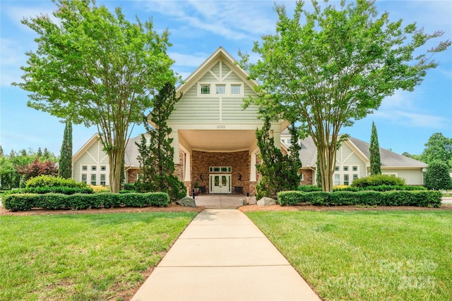 12910 Meetinghouse Dr, Cornelius, NC 28031 - view of front of home with french doors, a front lawn, and brick siding